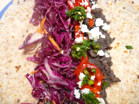 refired black beans with red cabbage slaw and zhoug on tortilla refired black beans with red cabbage slaw and zhoug on tortilla