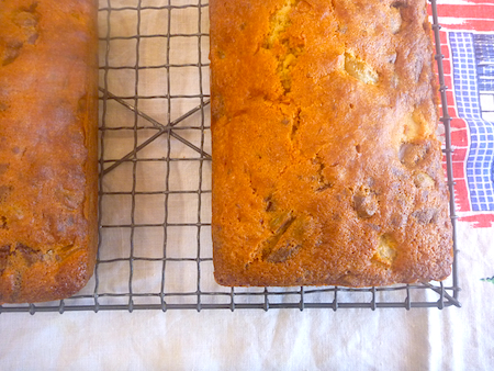 Pear pistachio and dark chocolate cake cooling on rack