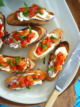 Whipped feta on bruschetta with tomato and herbs Whipped feta on bruschetta with tomato and herbs