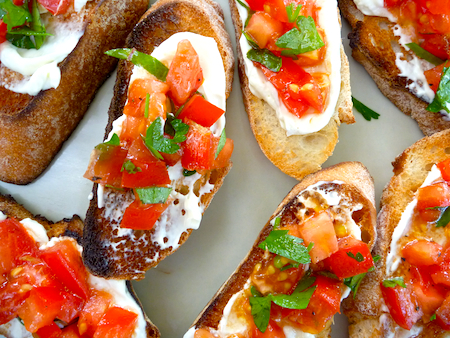 Whipped feta on bruschetta with tomato and herbs Whipped feta on bruschetta with tomato and herbs