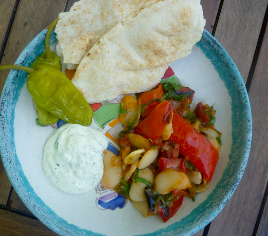 Greek vegetarian baked beans with tzatziki, pickles and bread.